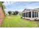 Wide shot of the well-manicured backyard, with grass and an enclosed sunroom at 19106 Mallard Dr # 216, Fort Mill, SC 29707