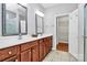 Well-lit bathroom with dual sinks, a walk-in shower, and access to a spacious walk-in closet at 19106 Mallard Dr # 216, Fort Mill, SC 29707