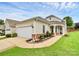 Charming single-story home featuring a well-manicured lawn, a two-car garage, and a welcoming front porch at 19106 Mallard Dr # 216, Fort Mill, SC 29707
