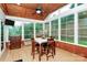 Bright sunroom with wood paneled ceiling, many windows, and a dining table and cabinet at 19106 Mallard Dr # 216, Fort Mill, SC 29707