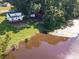 Aerial view showcasing a white house with a deck next to a pond at 1918 Gables Dr, Monroe, NC 28112