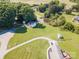 Scenic aerial view of a home with a tranquil pond, lush trees, and well-maintained lawn at 1918 Gables Dr, Monroe, NC 28112
