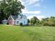 Spacious backyard with lush greenery, storage shed, and pond views creates a private retreat at 1918 Gables Dr, Monroe, NC 28112