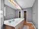 Bathroom featuring a double sink vanity, a large mirror and hardwood floors at 1918 Gables Dr, Monroe, NC 28112