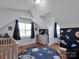 ' bedroom with a playful space theme featuring light blue walls and wood flooring at 1918 Gables Dr, Monroe, NC 28112