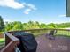 Outdoor deck overlooking a serene pond, perfect for relaxing and enjoying nature at 1918 Gables Dr, Monroe, NC 28112