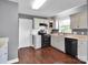 Bright kitchen with white cabinetry, black appliances and hardwood flooring at 1918 Gables Dr, Monroe, NC 28112