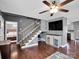 Inviting living room featuring hardwood floors, a ceiling fan, and staircase leading to the upper level at 1918 Gables Dr, Monroe, NC 28112
