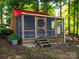 Charming screened outbuilding with a red roof, nestled among lush trees providing shade at 1918 Gables Dr, Monroe, NC 28112