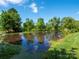 Calm pond view with clear blue sky reflecting off the water, creating a serene atmosphere at 1918 Gables Dr, Monroe, NC 28112