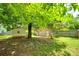 View of a large backyard with a storage shed and mature trees providing shade at 2001 Lakeview Dr, Pineville, NC 28134