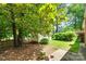 Backyard featuring a storage shed with lush greenery and trees, offering a serene outdoor space at 2001 Lakeview Dr, Pineville, NC 28134