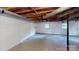 Unfinished basement with concrete floors, painted walls, exposed ceiling, and natural light at 2001 Lakeview Dr, Pineville, NC 28134