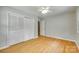 Comfortable bedroom features wood floors, ceiling fan, and closet at 2001 Lakeview Dr, Pineville, NC 28134