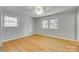 This bedroom features hardwood floors, two windows and neutral paint and trim at 2001 Lakeview Dr, Pineville, NC 28134