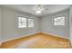Cozy bedroom featuring gleaming wood floors and sun-filled double windows at 2001 Lakeview Dr, Pineville, NC 28134