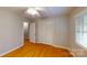 Neutral bedroom with hardwood floors, a closet, and large windows with blinds for natural light at 2001 Lakeview Dr, Pineville, NC 28134