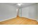 Bright bedroom features wood floors, ceiling fan, and closet space at 2001 Lakeview Dr, Pineville, NC 28134