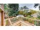 Wooden deck overlooking the expansive, fully fenced backyard with mature trees and lush landscaping at 2001 Lakeview Dr, Pineville, NC 28134