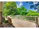 Outdoor wooden deck with railings and green foliage at 2001 Lakeview Dr, Pineville, NC 28134