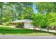 A charming single-story home featuring a well-manicured lawn and mature trees in a serene setting at 2001 Lakeview Dr, Pineville, NC 28134