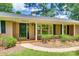 Close-up of brick facade, black door, and manicured landscaping at this home's entrance at 2001 Lakeview Dr, Pineville, NC 28134