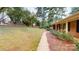 Brick home featuring mature landscaping, a sidewalk and a glimpse of a charming, tree-lined yard at 2001 Lakeview Dr, Pineville, NC 28134