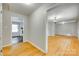 Spacious hallway featuring gleaming hardwood floors and inviting doorway to other rooms at 2001 Lakeview Dr, Pineville, NC 28134