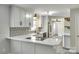 This kitchen features white cabinets and counter tops, stainless appliances and tile backsplash at 2001 Lakeview Dr, Pineville, NC 28134