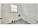 Utility Room with washer/dryer hookups, white walls and baseboards and tiled floors at 2001 Lakeview Dr, Pineville, NC 28134