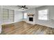 Spacious living room featuring a painted fireplace and built-in shelving at 2001 Lakeview Dr, Pineville, NC 28134