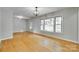 Bright and airy living room boasts large windows and gleaming hardwood floors at 2001 Lakeview Dr, Pineville, NC 28134