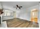 Open-concept living room boasts vinyl floors, ceiling fan and stylish decor at 2001 Lakeview Dr, Pineville, NC 28134