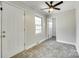Neutral room features tiled floors, white walls, ceiling fan and a single window for lots of light at 2001 Lakeview Dr, Pineville, NC 28134