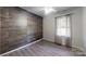 Bedroom with decorative wood wall, ceiling fan, and natural light at 2026 Willow Ridge St, Conover, NC 28613