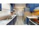 Galley kitchen with blue cabinets, stainless steel appliances, and wood flooring at 2026 Willow Ridge St, Conover, NC 28613
