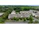 Aerial view showcases brick and siding townhomes with mature trees and sidewalks, located in a desirable residential area at 206 Overstone Ct, Fort Mill, SC 29715