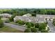 Aerial view showcases brick and siding townhomes with mature trees and sidewalks, located in a desirable residential area at 206 Overstone Ct, Fort Mill, SC 29715
