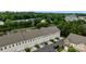Aerial view of a townhome complex with attached garages, well-manicured lawns, and tree-lined streets creating a desirable community at 206 Overstone Ct, Fort Mill, SC 29715