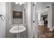 Bathroom with a pedestal sink, a large mirror, and a view of the kitchen at 206 Overstone Ct, Fort Mill, SC 29715