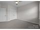 A spacious bedroom with carpet, a ceiling fan, and a closet with double doors at 206 Overstone Ct, Fort Mill, SC 29715