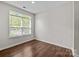 Bright bedroom featuring wood-look floors and a large window offering ample natural light at 206 Overstone Ct, Fort Mill, SC 29715