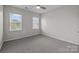 Bedroom featuring carpet, two windows with blinds, and neutral walls at 206 Overstone Ct, Fort Mill, SC 29715