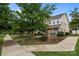 Townhome community entrance with brick sign, sidewalks, and manicured landscaping, creating an inviting neighborhood setting at 206 Overstone Ct, Fort Mill, SC 29715