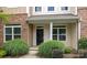 Close up of the entrance to a charming townhome with manicured landscaping at 206 Overstone Ct, Fort Mill, SC 29715