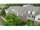 An aerial shot highlights brick accents and double-hung windows in this well-maintained townhouse row at 206 Overstone Ct, Fort Mill, SC 29715