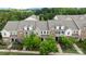 Charming brick townhomes offer inviting front porches and classic architectural details in a verdant setting at 206 Overstone Ct, Fort Mill, SC 29715