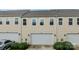 Townhome featuring attached garage and street parking, complemented by well-maintained lawn and ornamental grasses at 206 Overstone Ct, Fort Mill, SC 29715