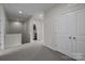 Upstairs hallway featuring plush carpeting, neutral walls and double door closet at 206 Overstone Ct, Fort Mill, SC 29715