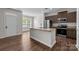 Kitchen with stainless appliances, modern cabinets, and a granite island for seating at 206 Overstone Ct, Fort Mill, SC 29715